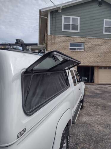 Windoors on both sides with velcro screening, hinged pass through window between shell and cab as well.
